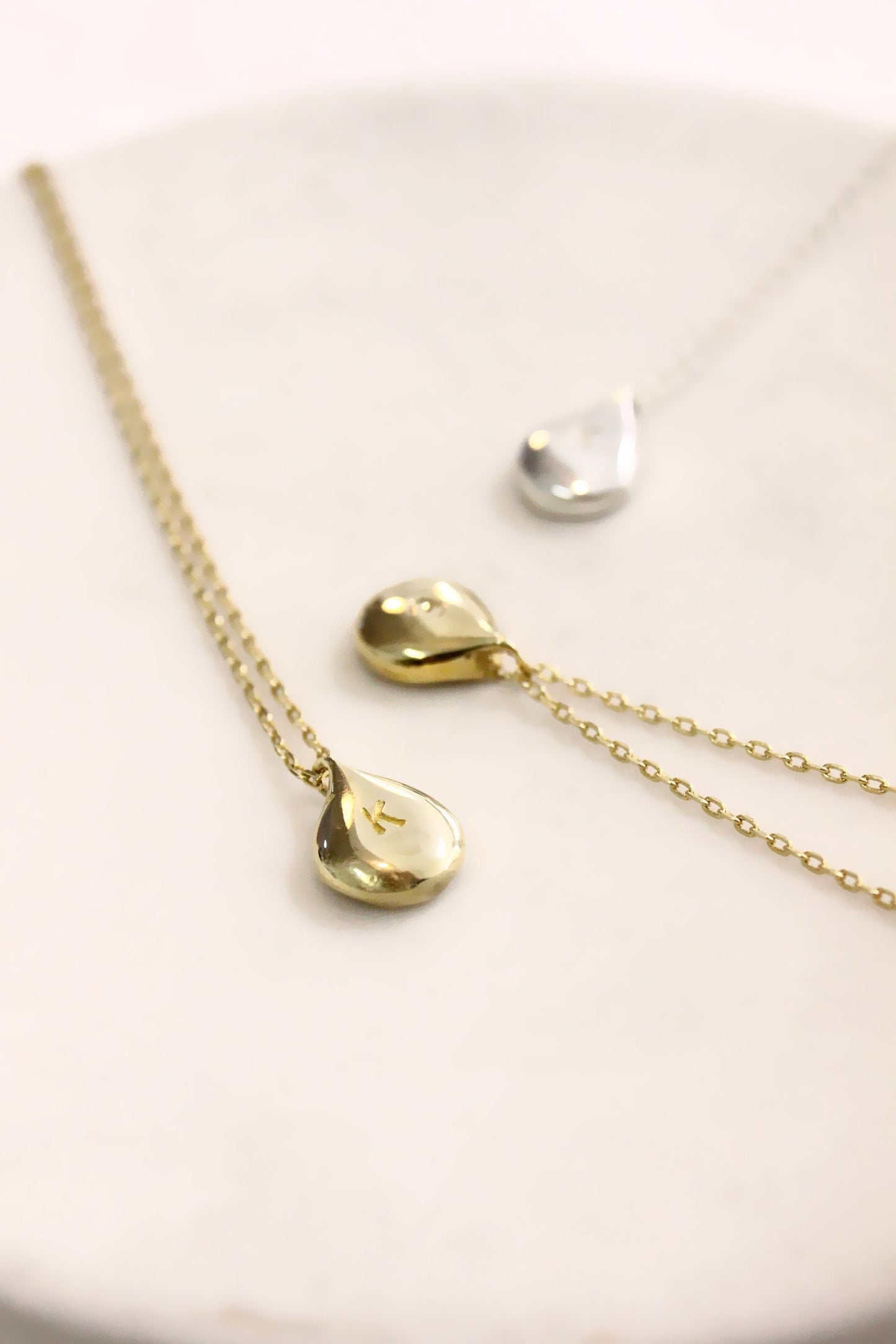 Gold necklace with teardrop pendants monogram