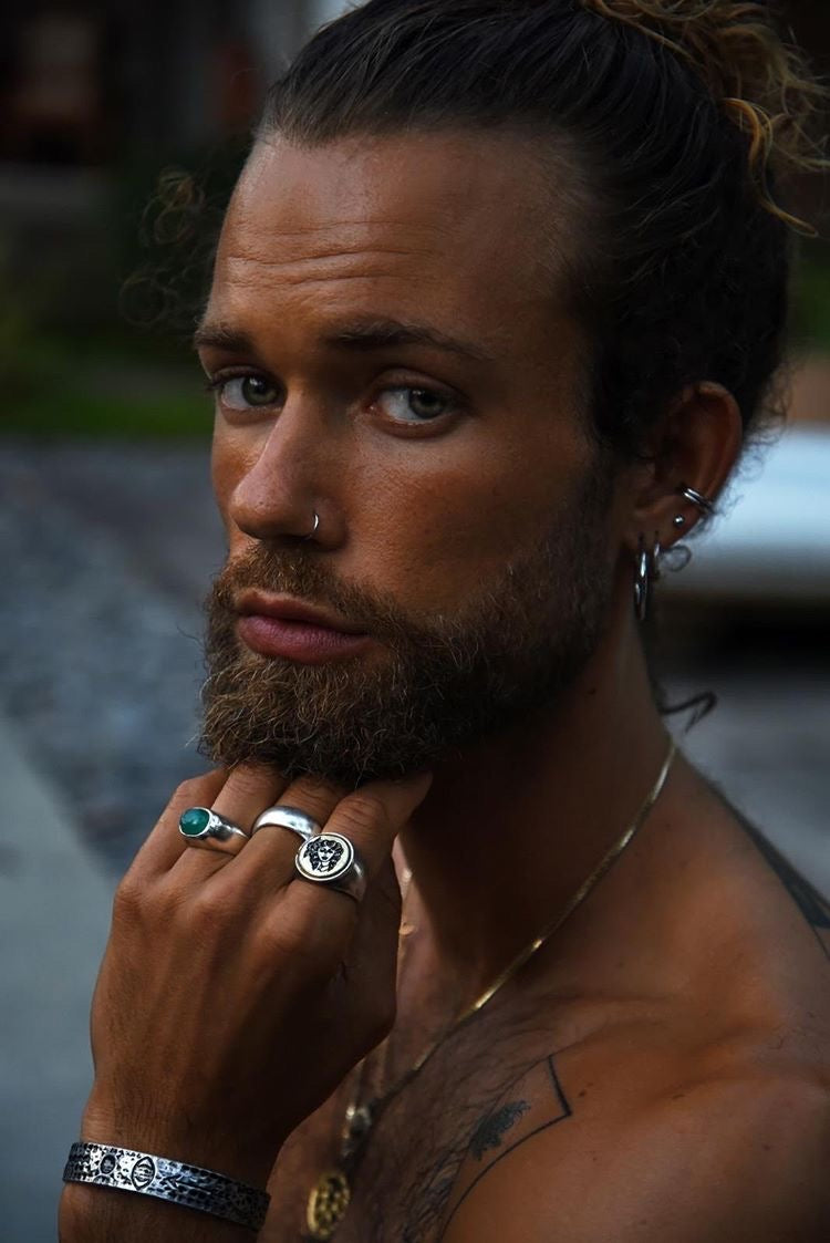Man with tattoos and jewelry