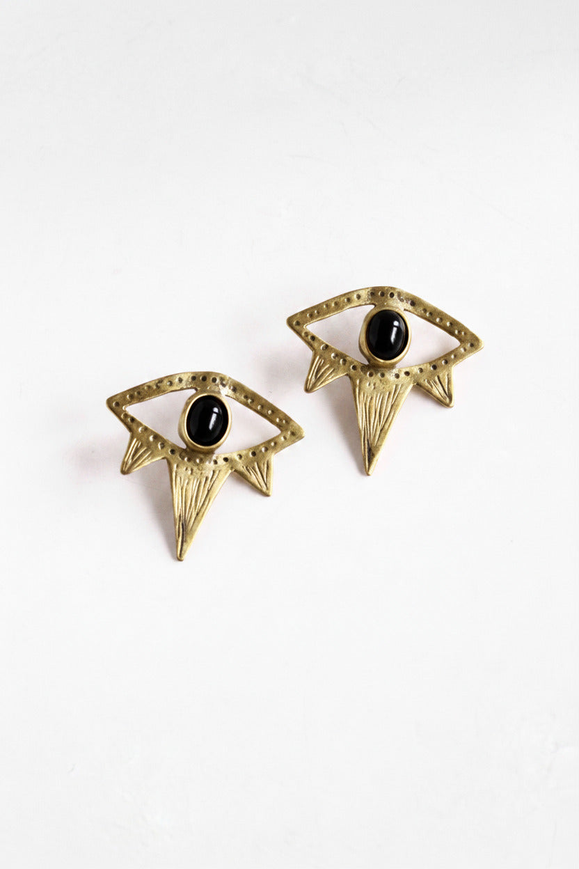 Gold earrings with black stones on a white background