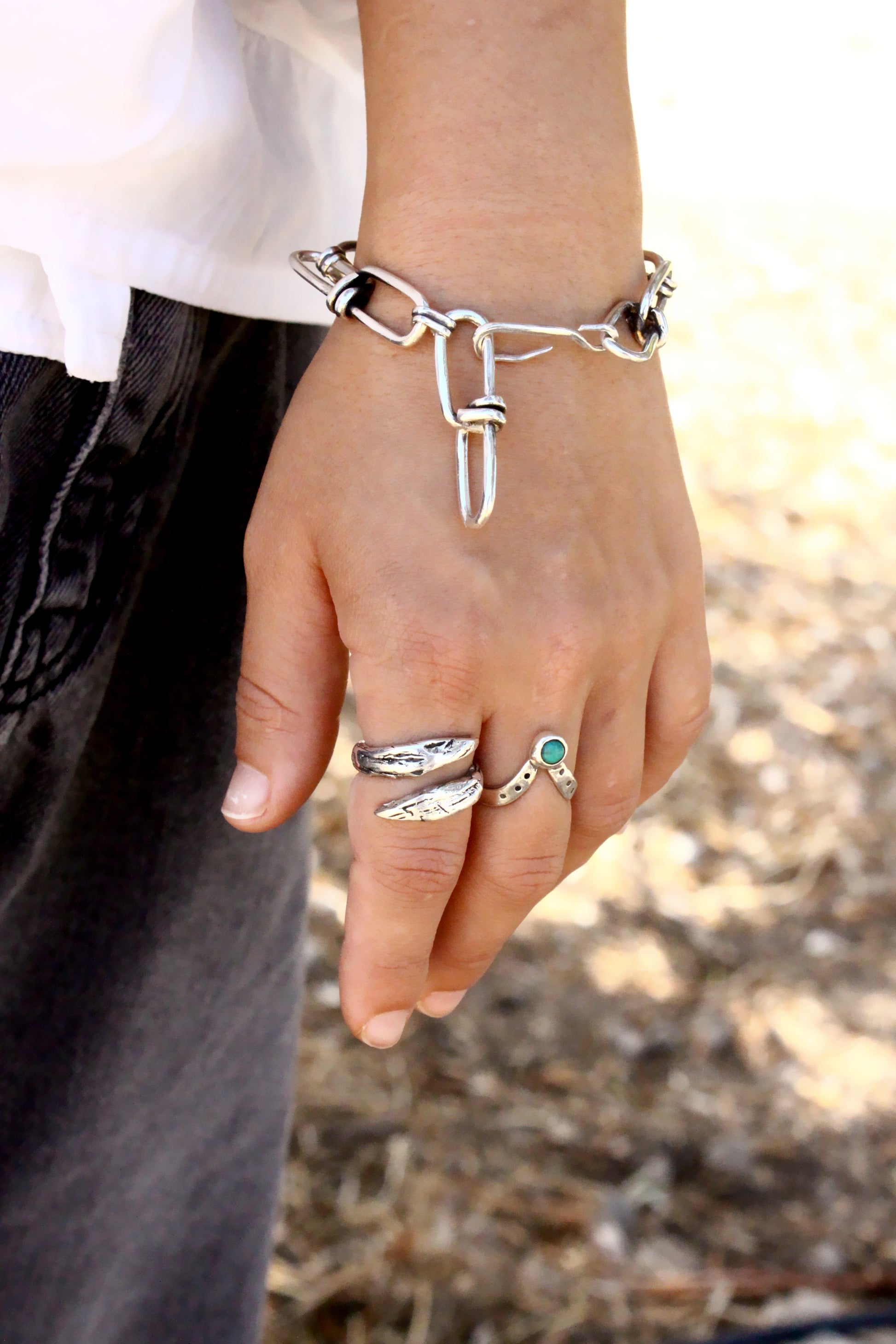 silver chain bracelet with multiple rings 