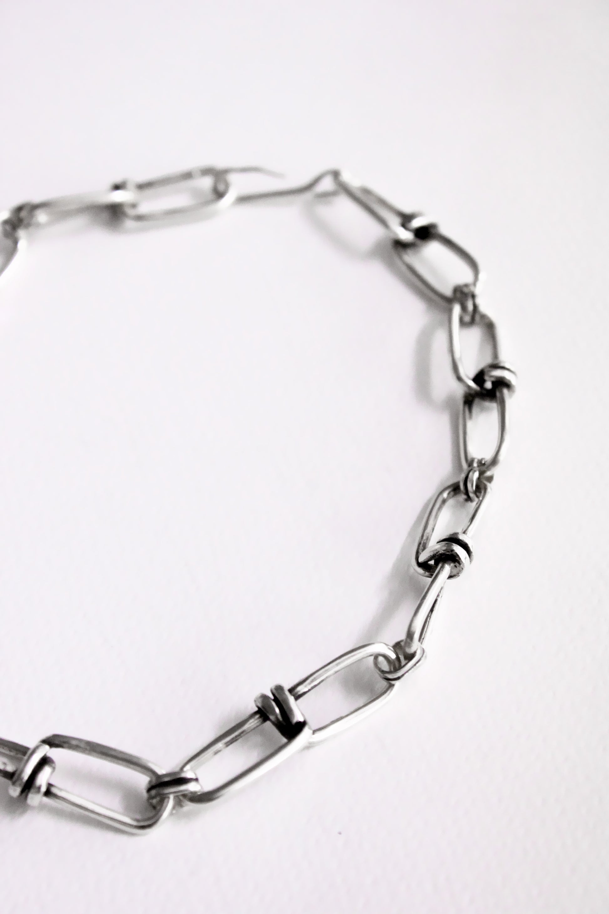 Silver chain bracelet on a white background