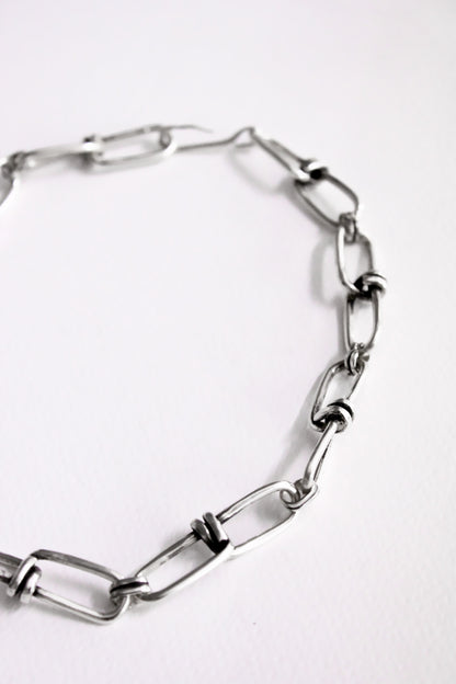 Silver chain bracelet on a white background