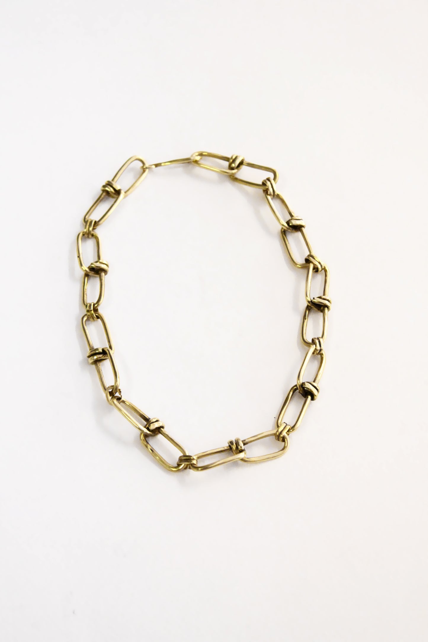 Gold chain necklace on a white background