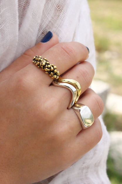 Stacking gold rings wavy molten liquid  