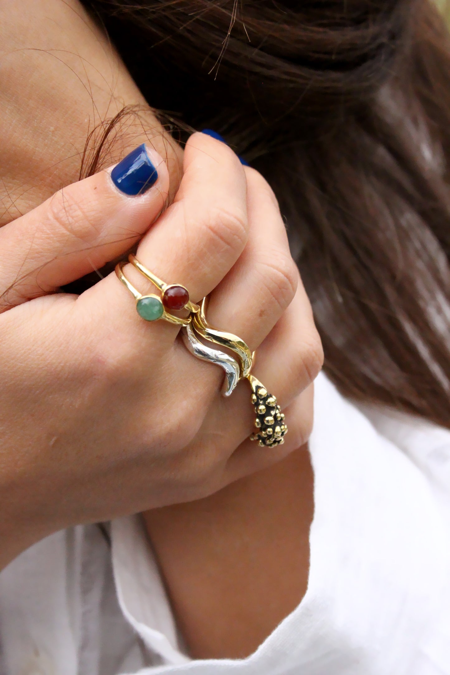 multiple rings with gemstones, wavy molten rings