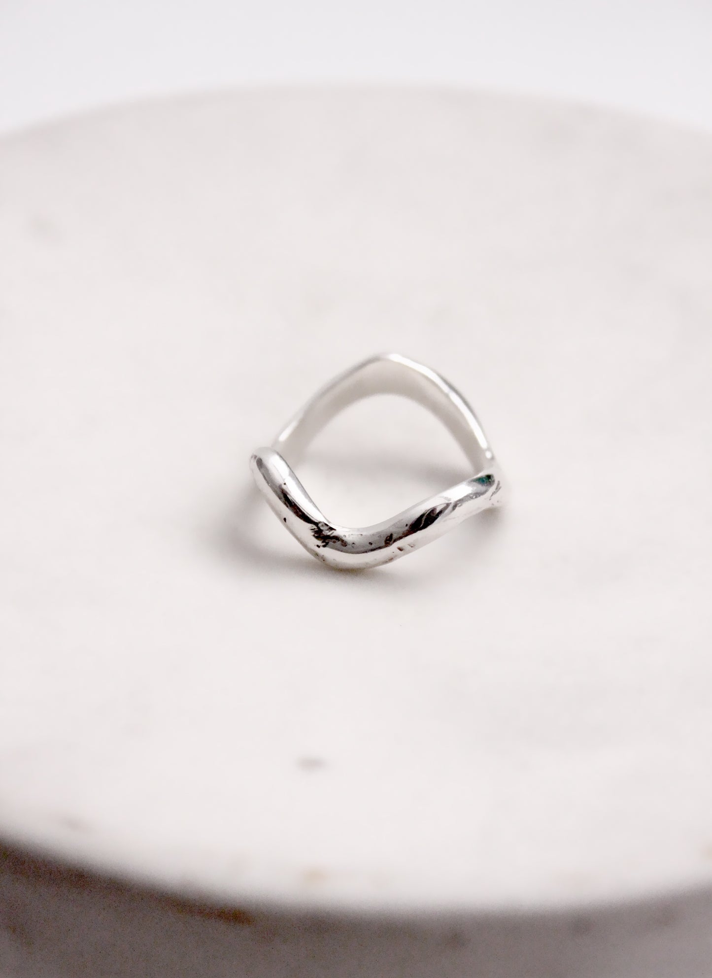 Silver wavy molten liquid ring