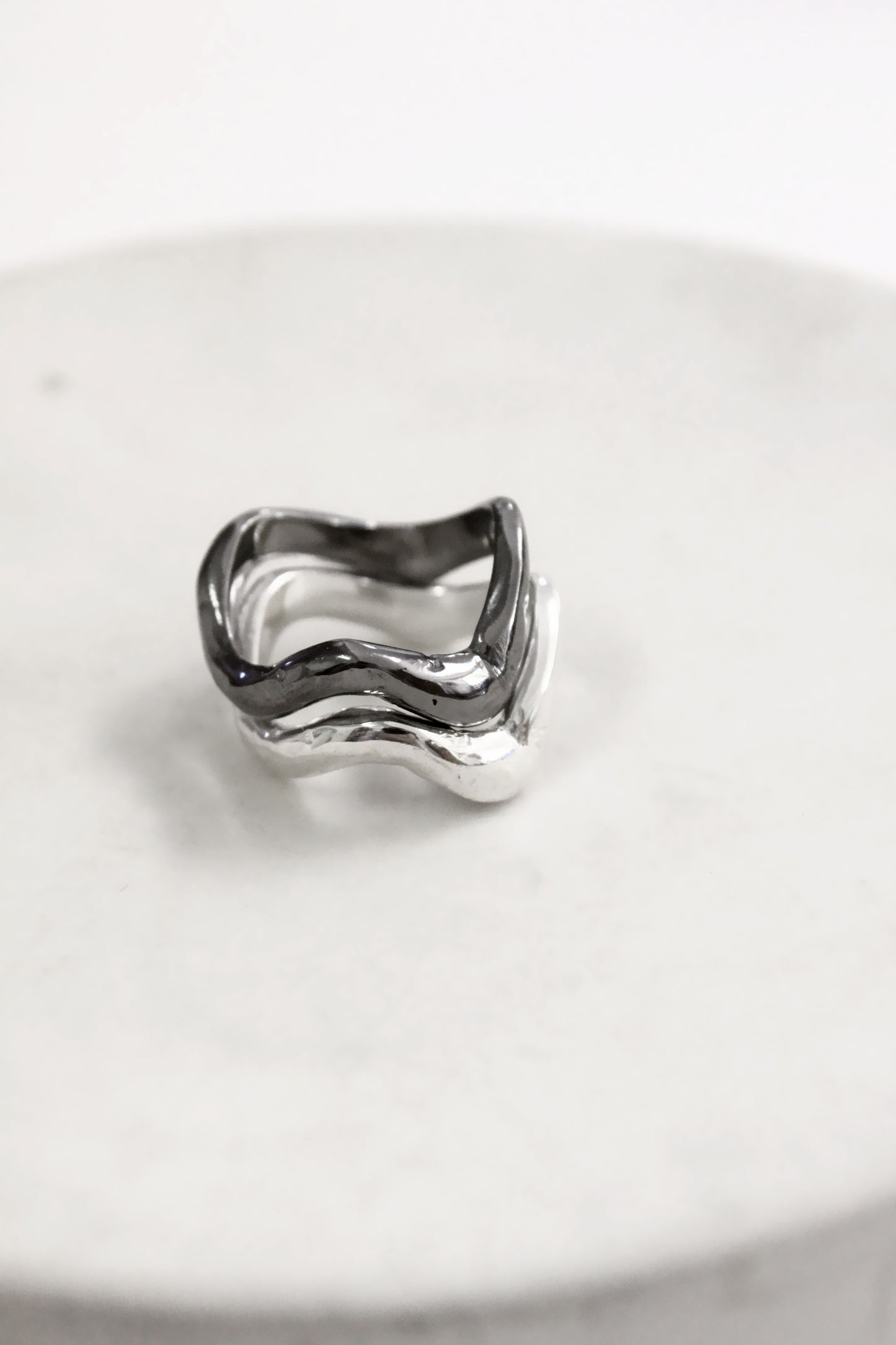 Silver black wavy molten liquid rings