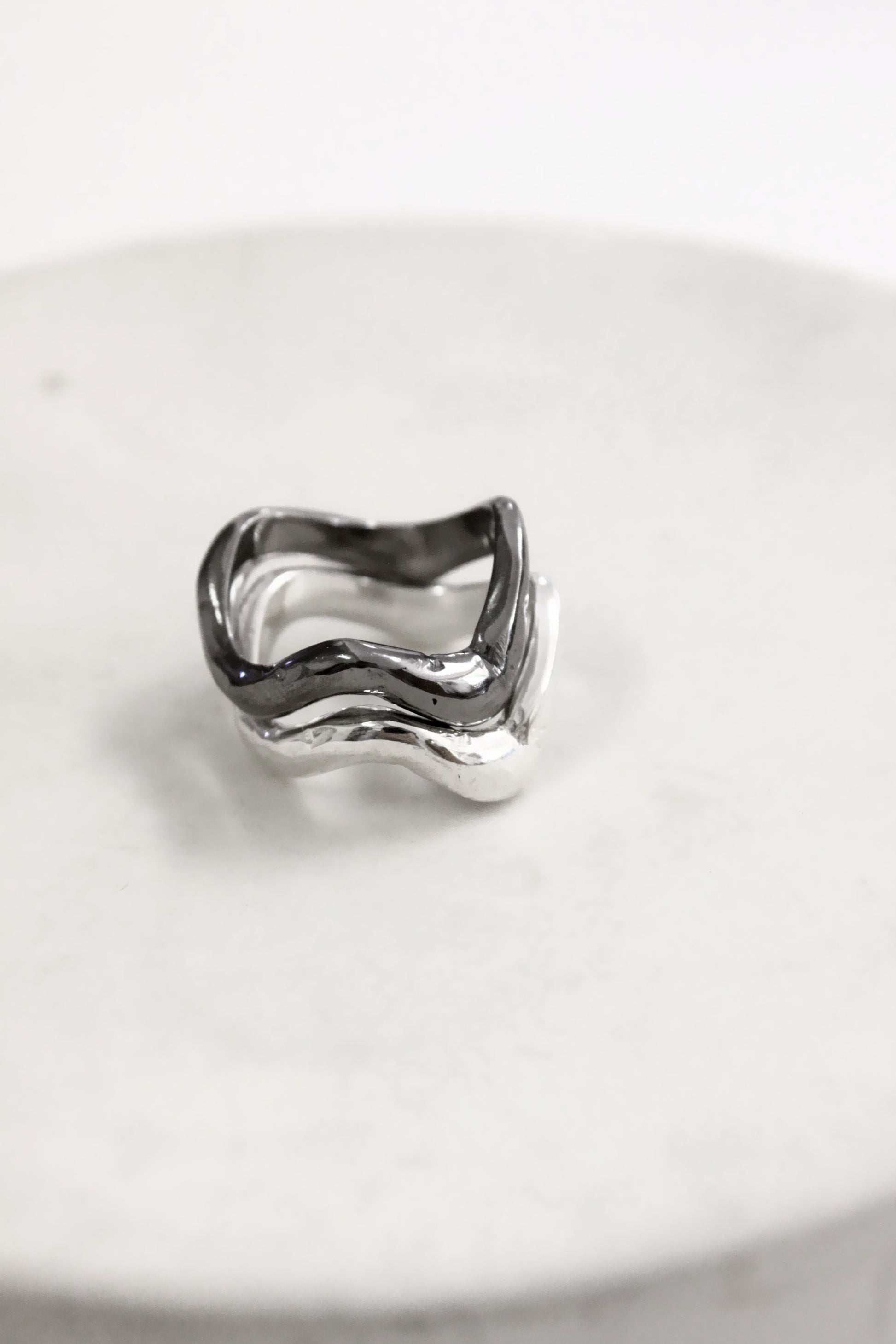 Silver black wavy molten liquid rings