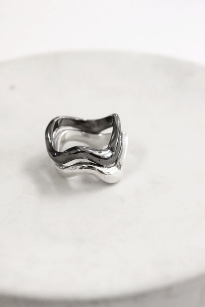 Silver black wavy molten liquid rings