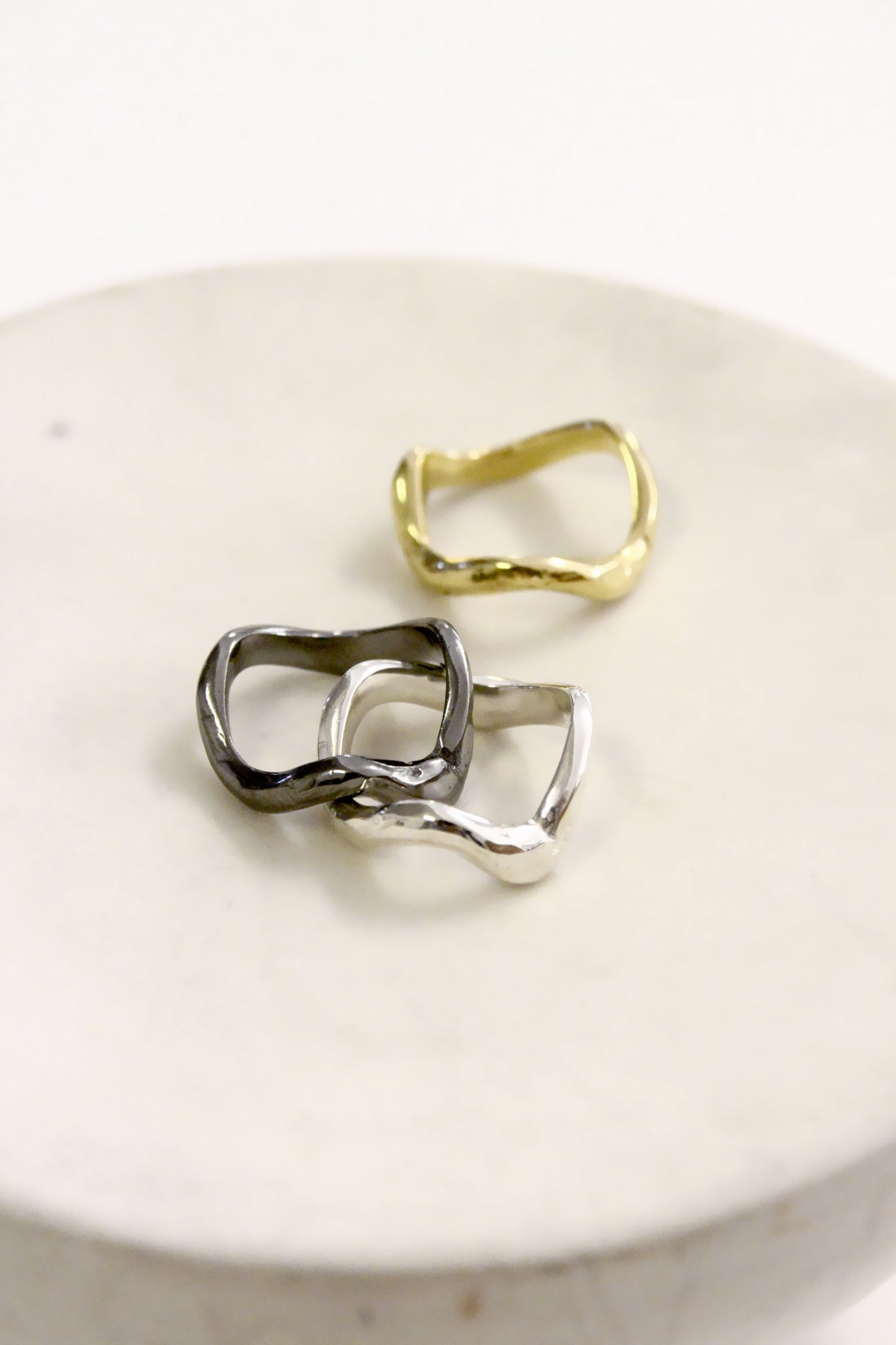 gold and silver wavy molten liquid  rings