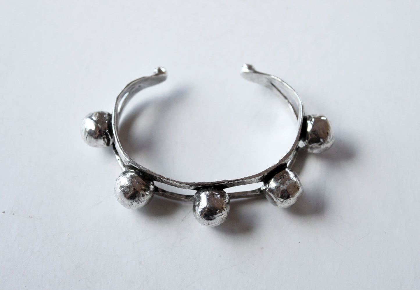 Silver bangle with spherical beads 