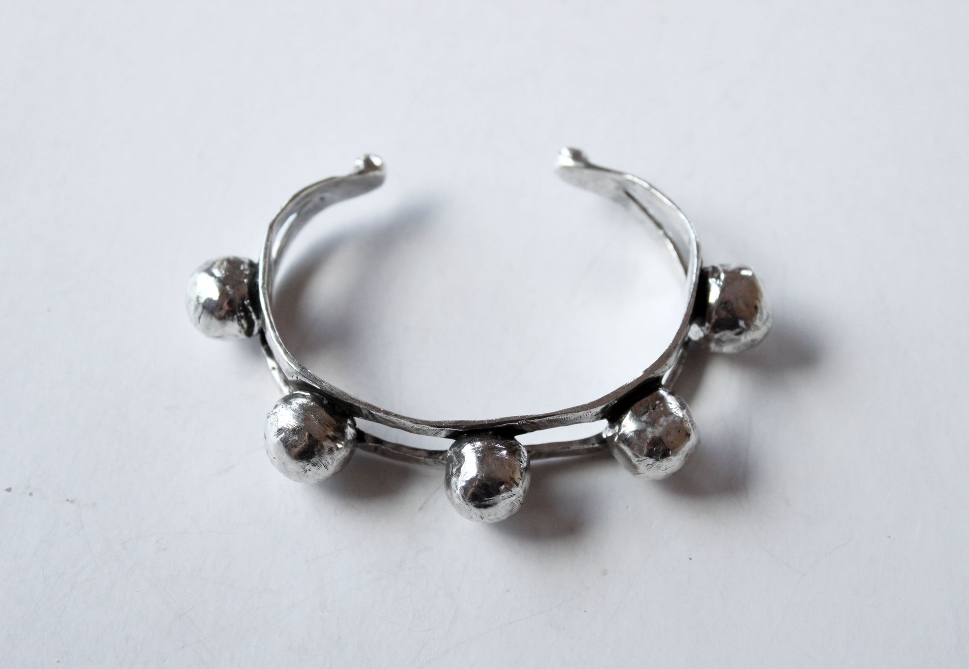 Silver bangle with spherical beads 