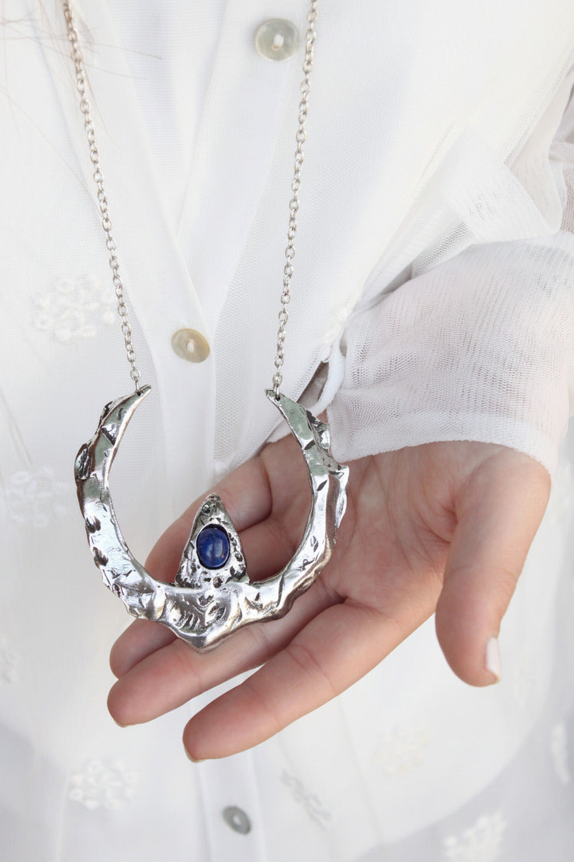  a silver necklace with a blue sodalite gemstone 