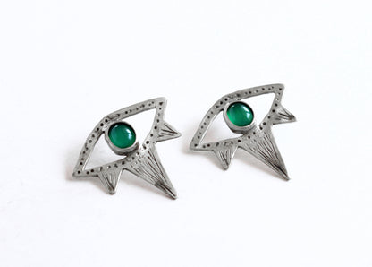 Pair of silver eyes earrings with green gemstones 