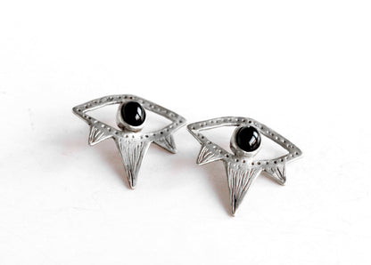 Pair of silver eyes earrings with black gemstones