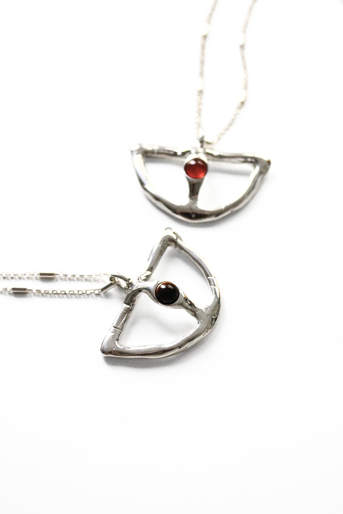 Two silver pendants with gemstones 