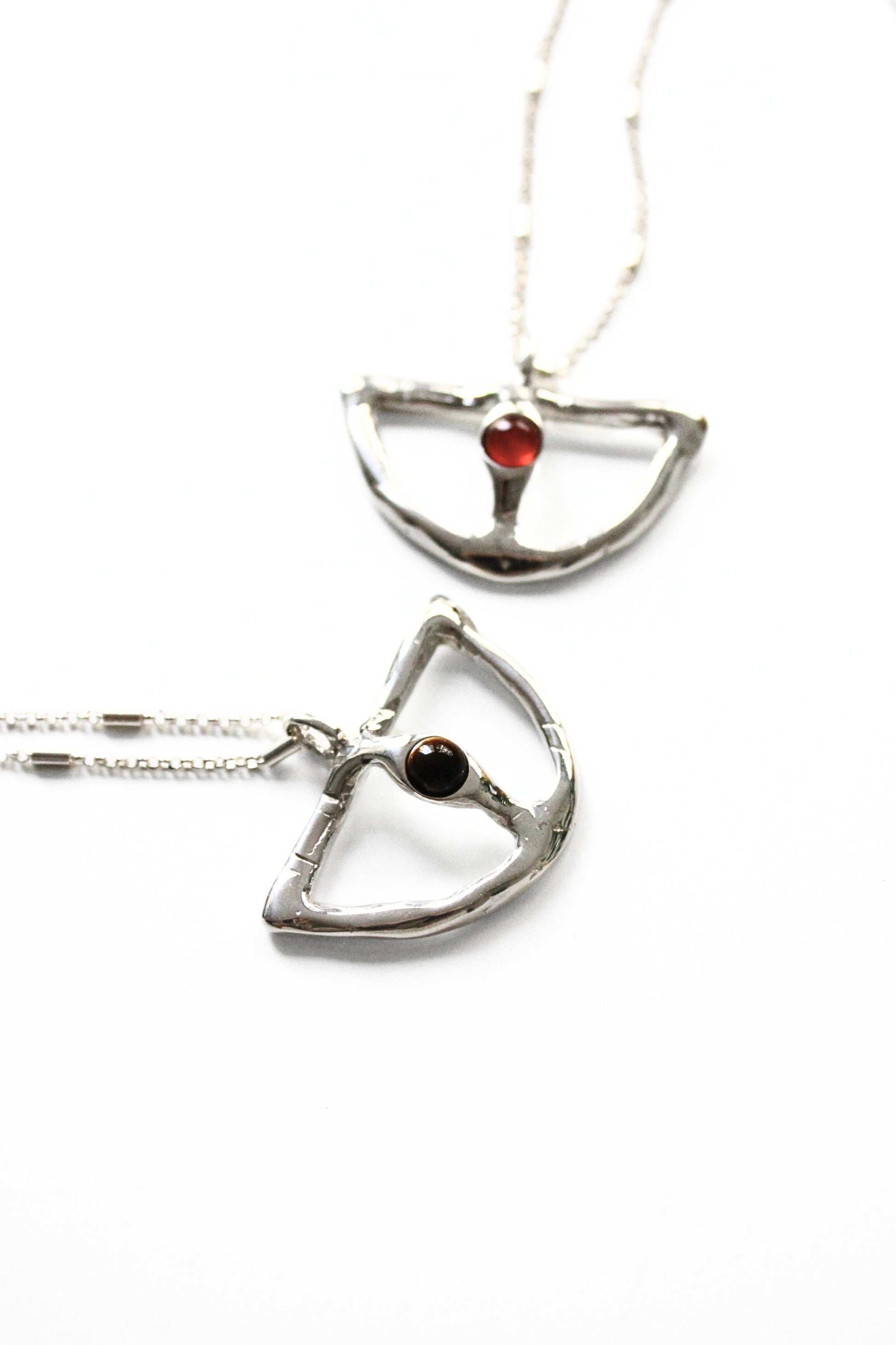 Two silver pendants with gemstones 