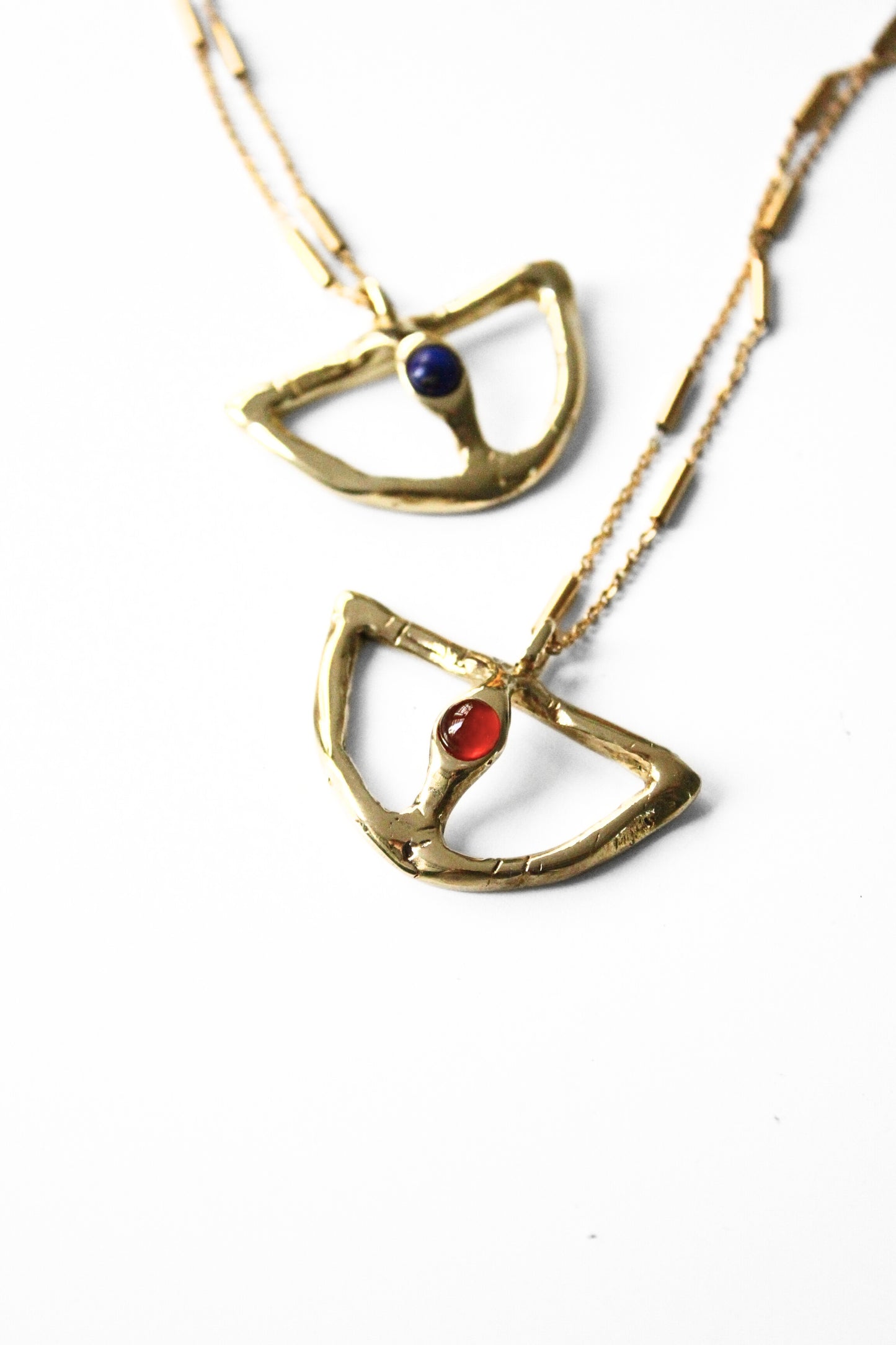 Two gold necklaces with gemstone pendants 