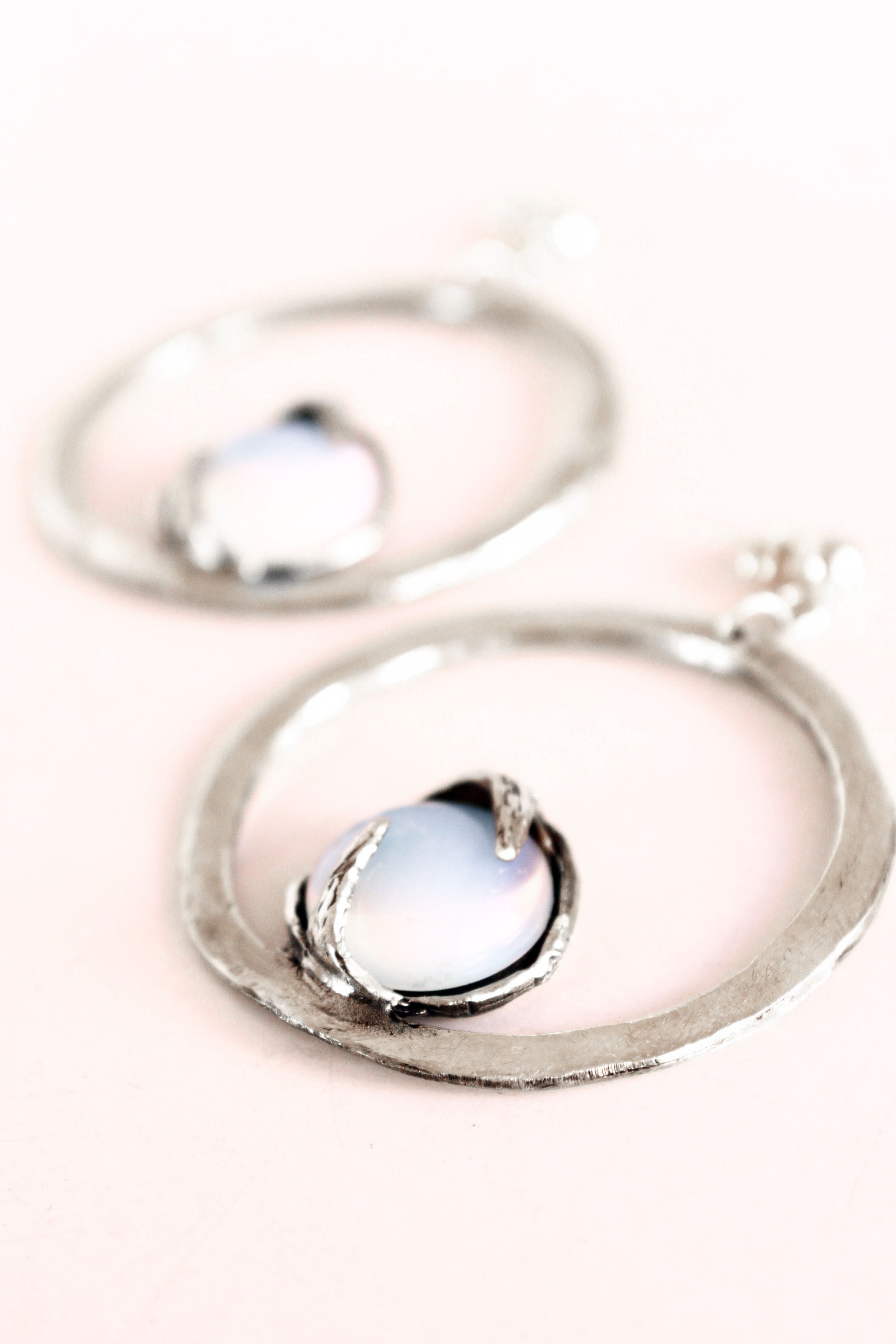 Silver earrings with a central opal gemstone 