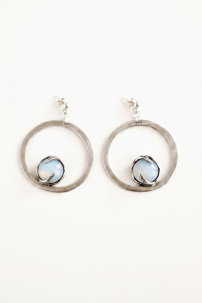 Silver hoop earrings with a central gemstone