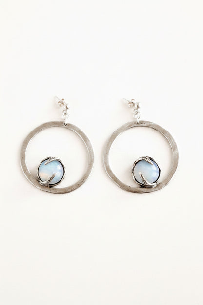 Silver hoop earrings with a central gemstone