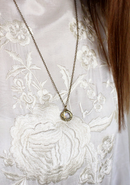 Necklace with a crystal pendant gold.