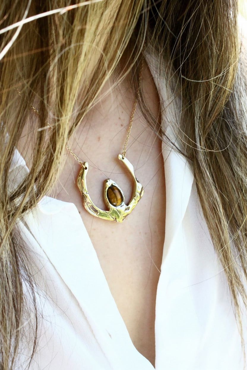 Gold necklace with a tigers eye pendant 