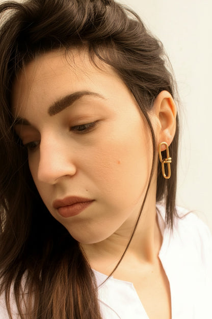  gold hoop earring with a plain background