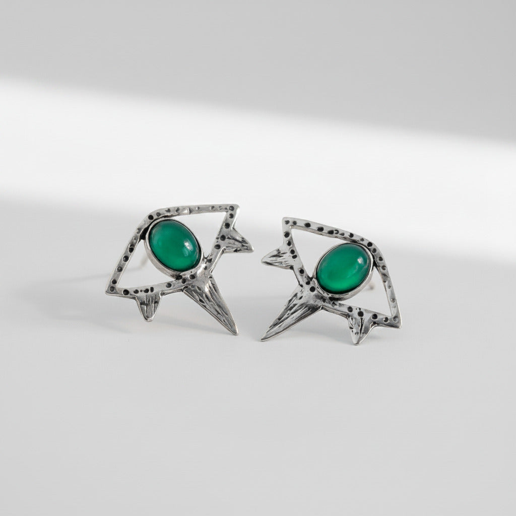 Pair of small eyes earrings with green gemstones 