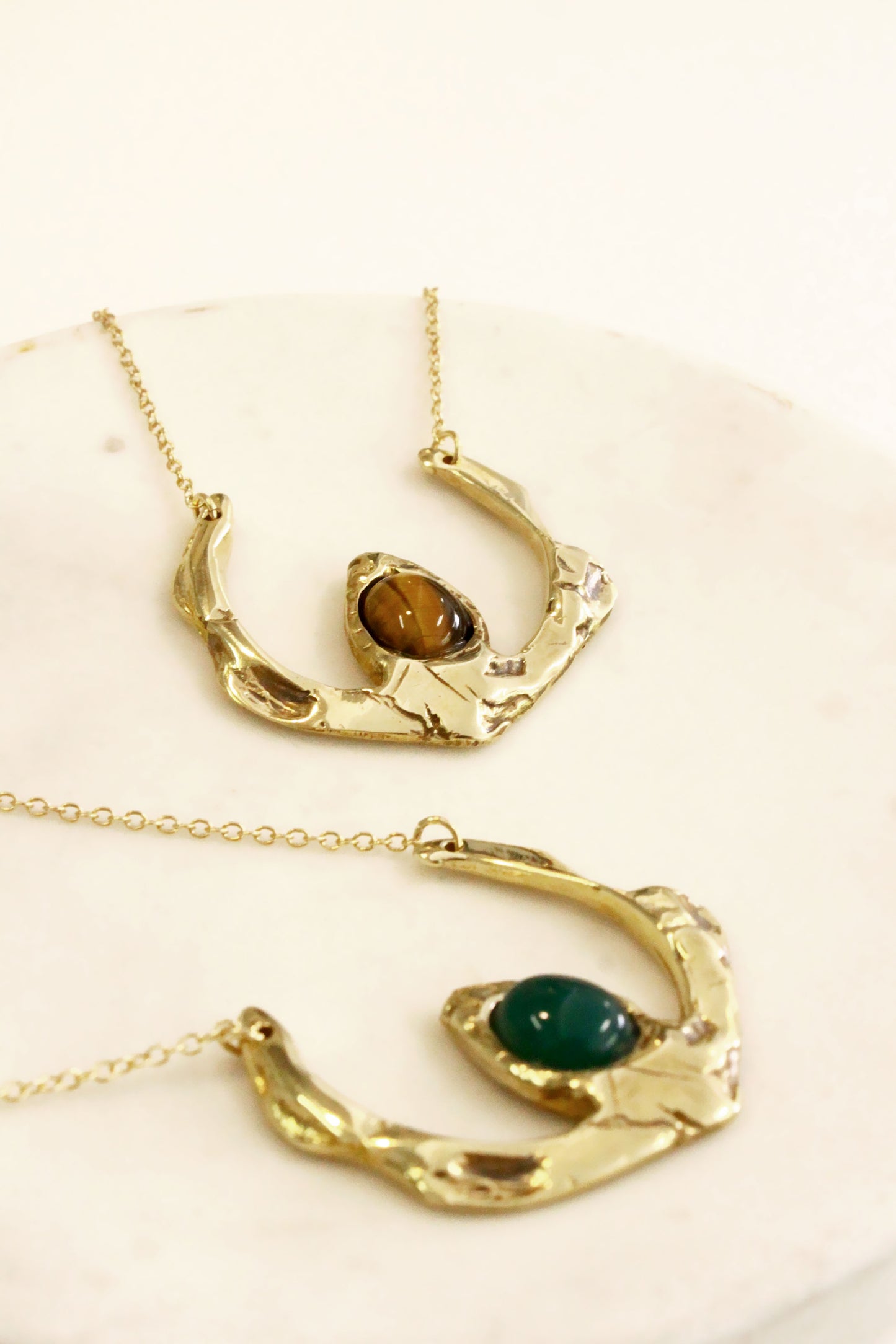 Two gold necklaces with gemstones 
