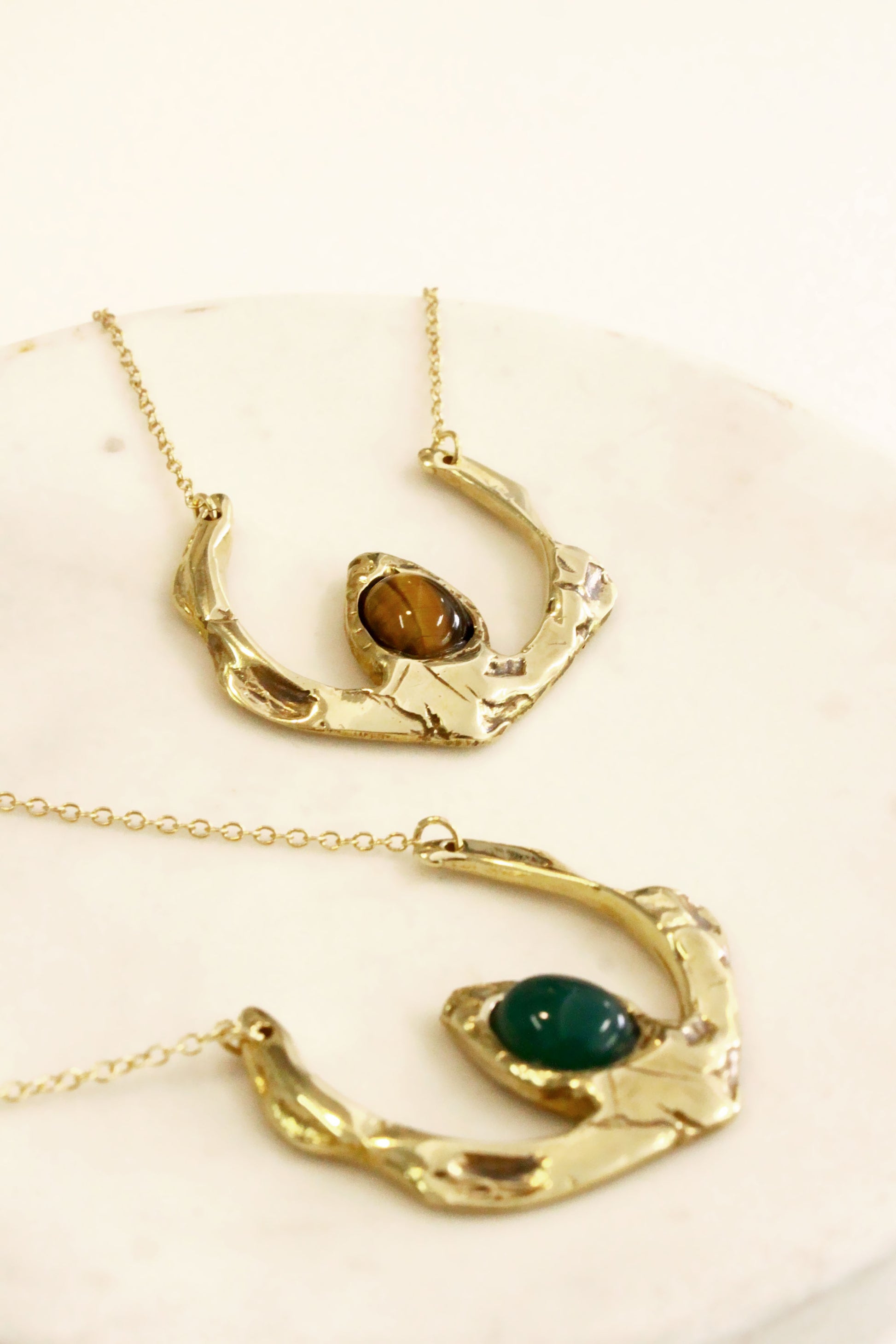 Two gold necklaces with gemstones 