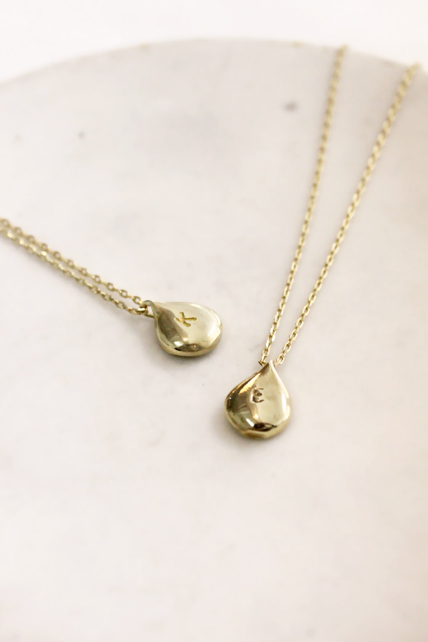 Gold teardrop-shaped pendants personalized initials