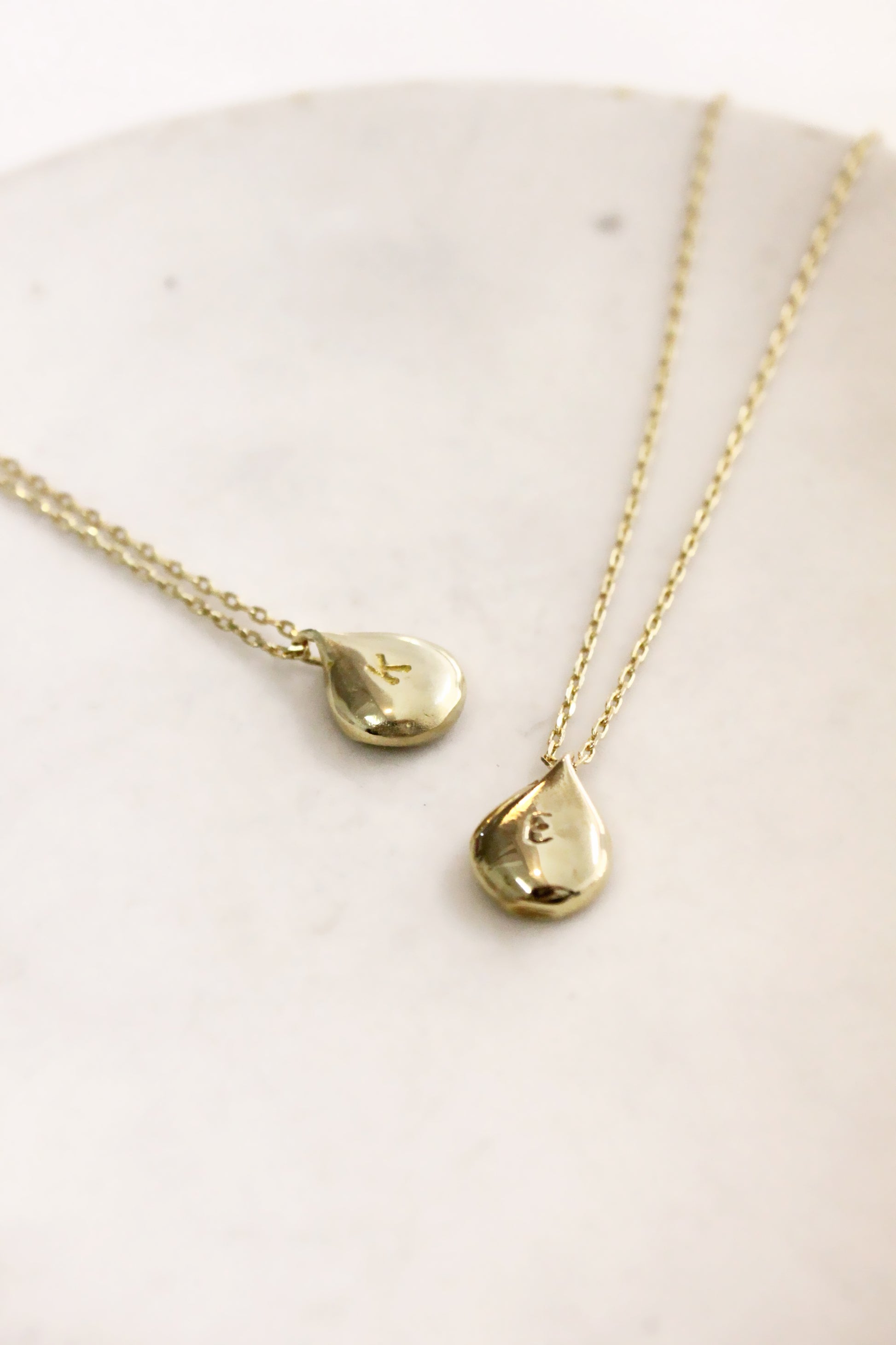Gold teardrop-shaped pendants personalized initials