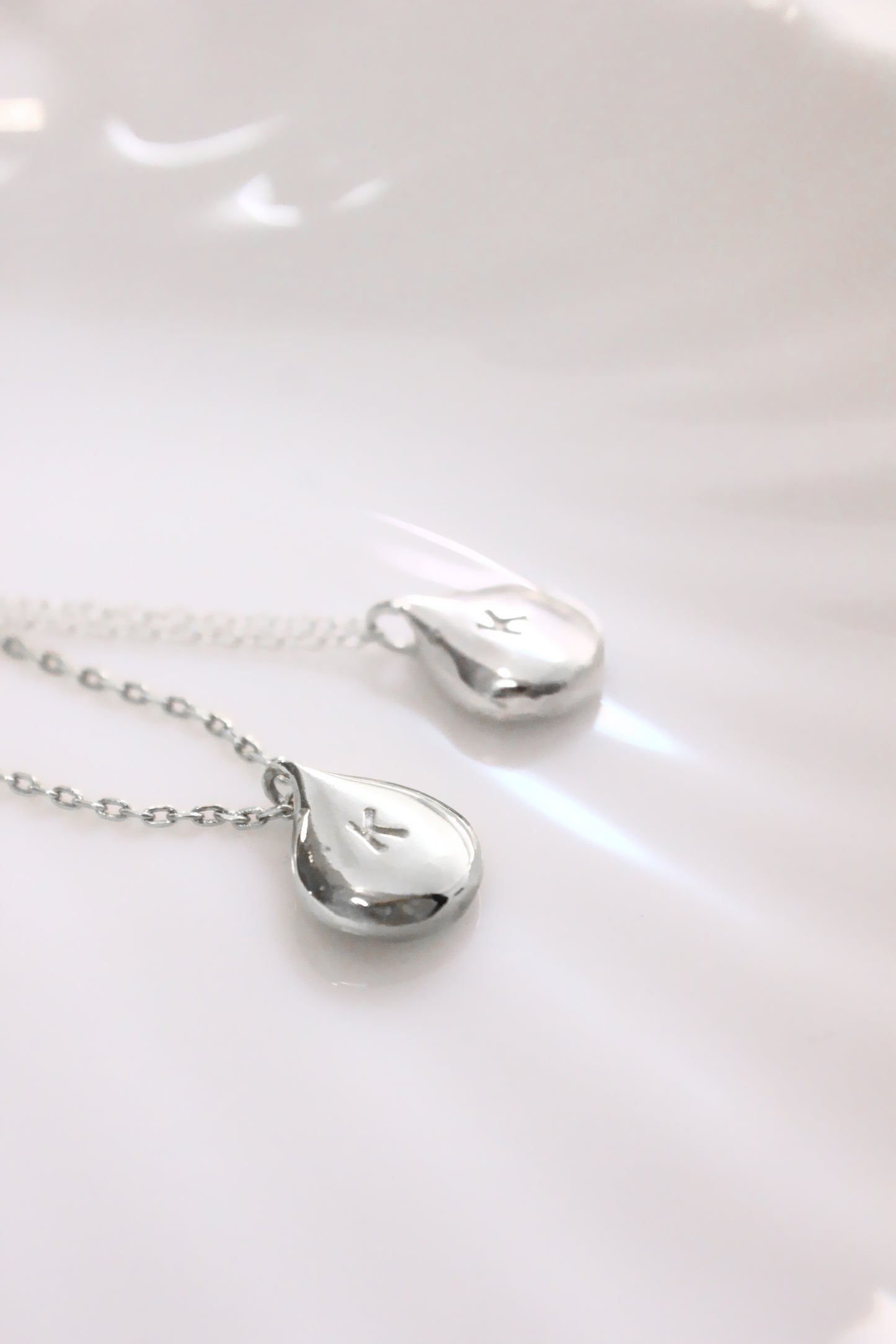 Silver necklace with teardrop-shaped ppersonalized initials monogram 