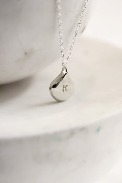 Silver necklace with a teardrop-shaped personalized initials monogram 