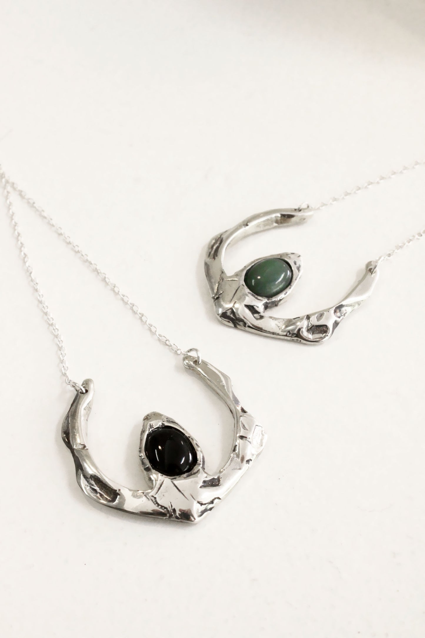 Two silver necklaces with black stones 