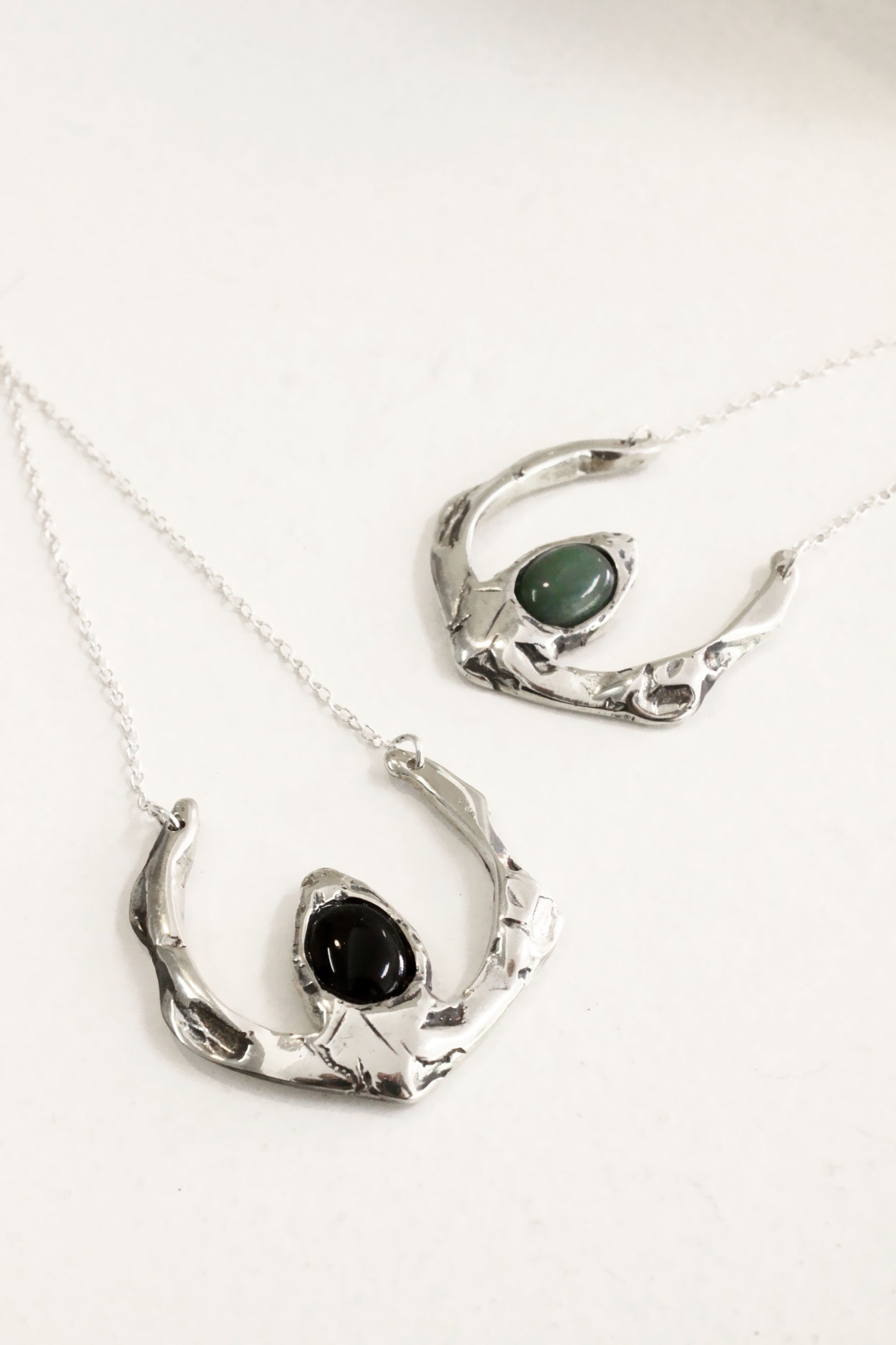 Two silver necklaces with black stones 