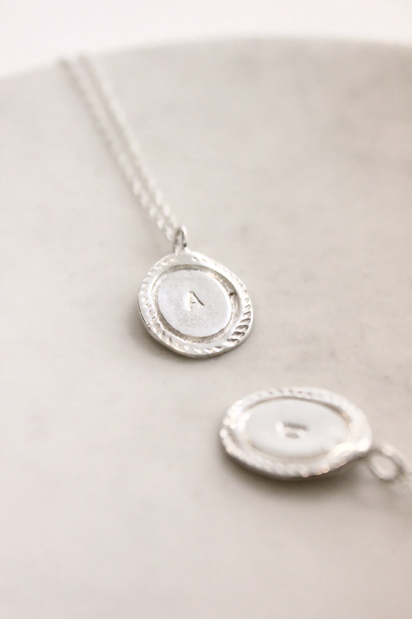 Silver necklace with a round pendant personalized initials monogram