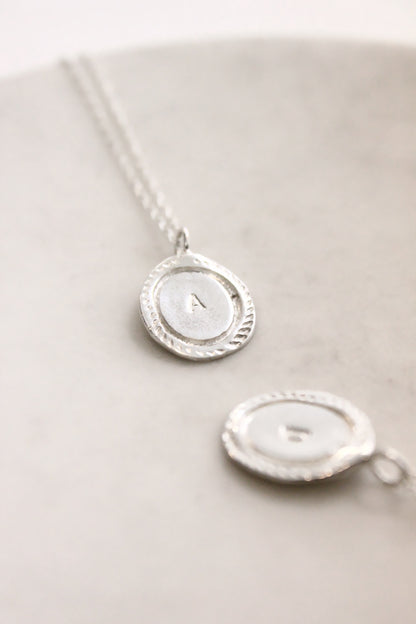 Silver necklace with a round pendant personalized initials monogram