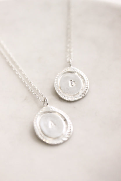 Two silver necklaces with circular pendants  personalized initials monogram