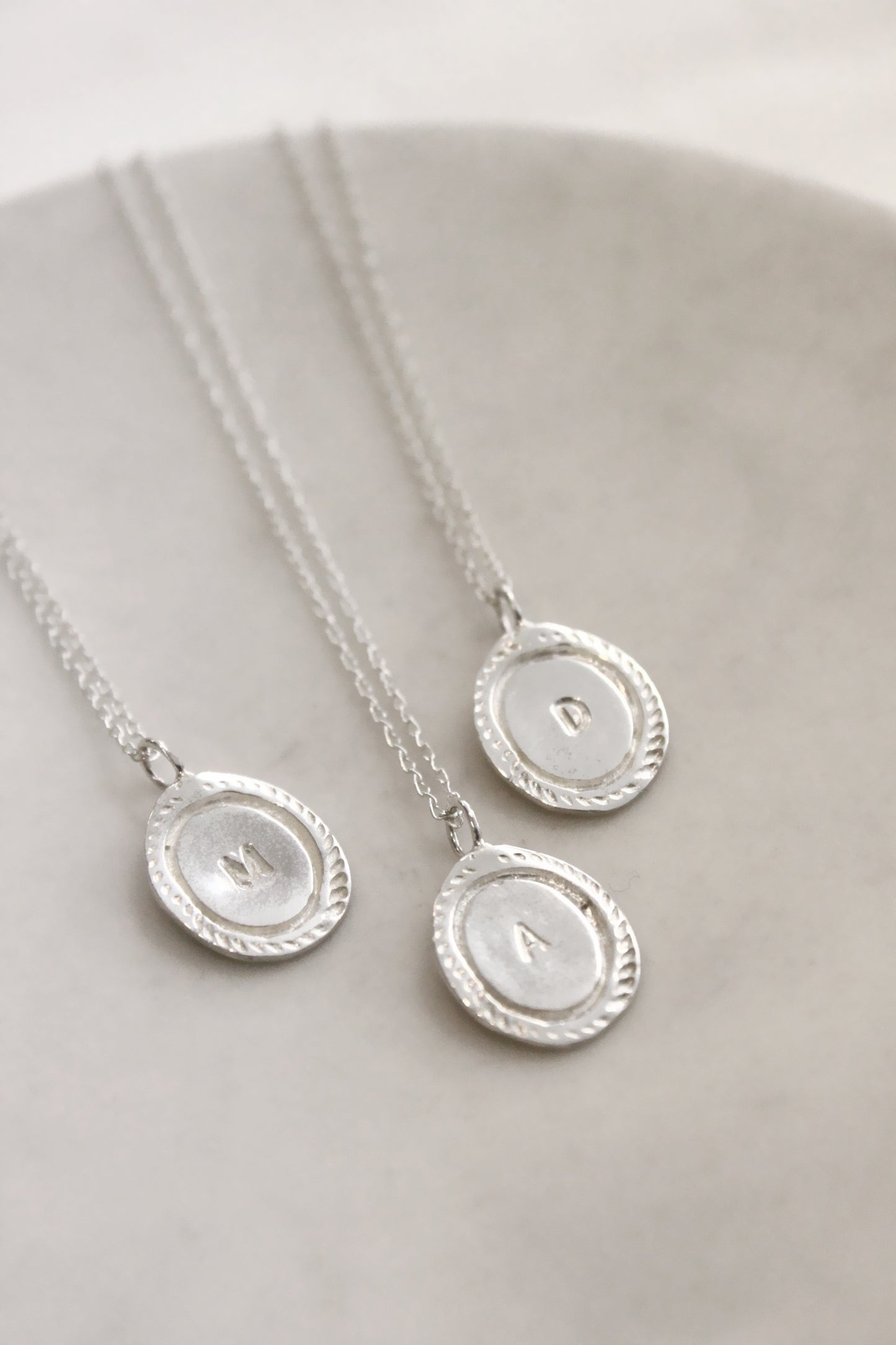 Silver necklaces with circular  personalized initials monogram 
