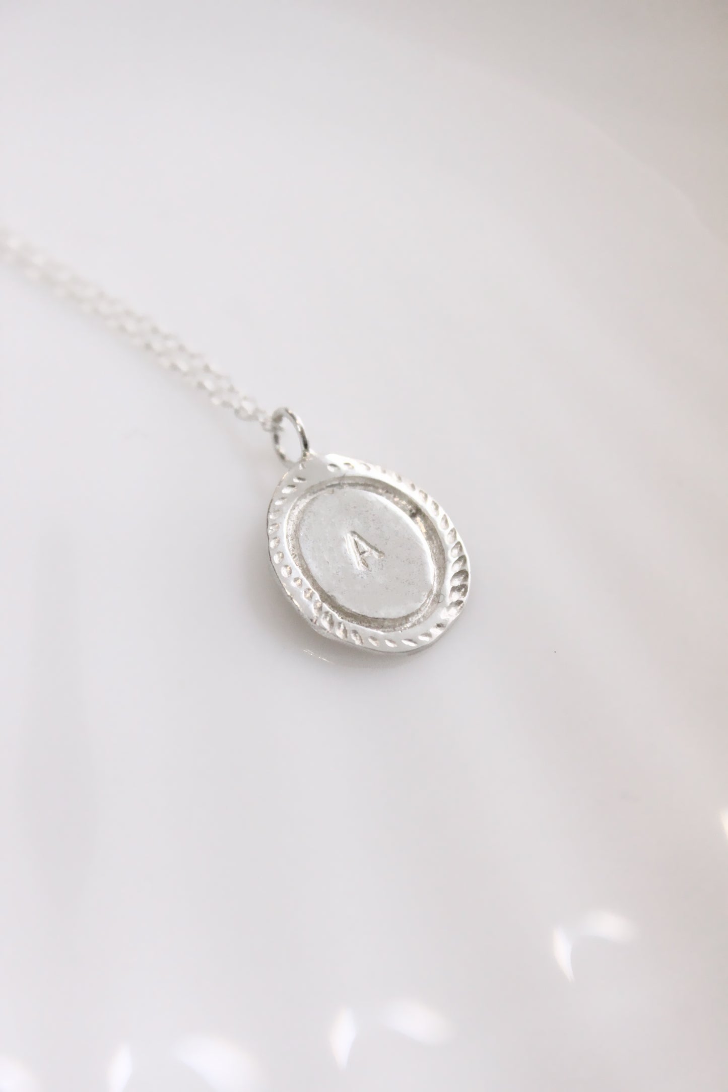 Silver necklace with a oval personalized initials monogram 