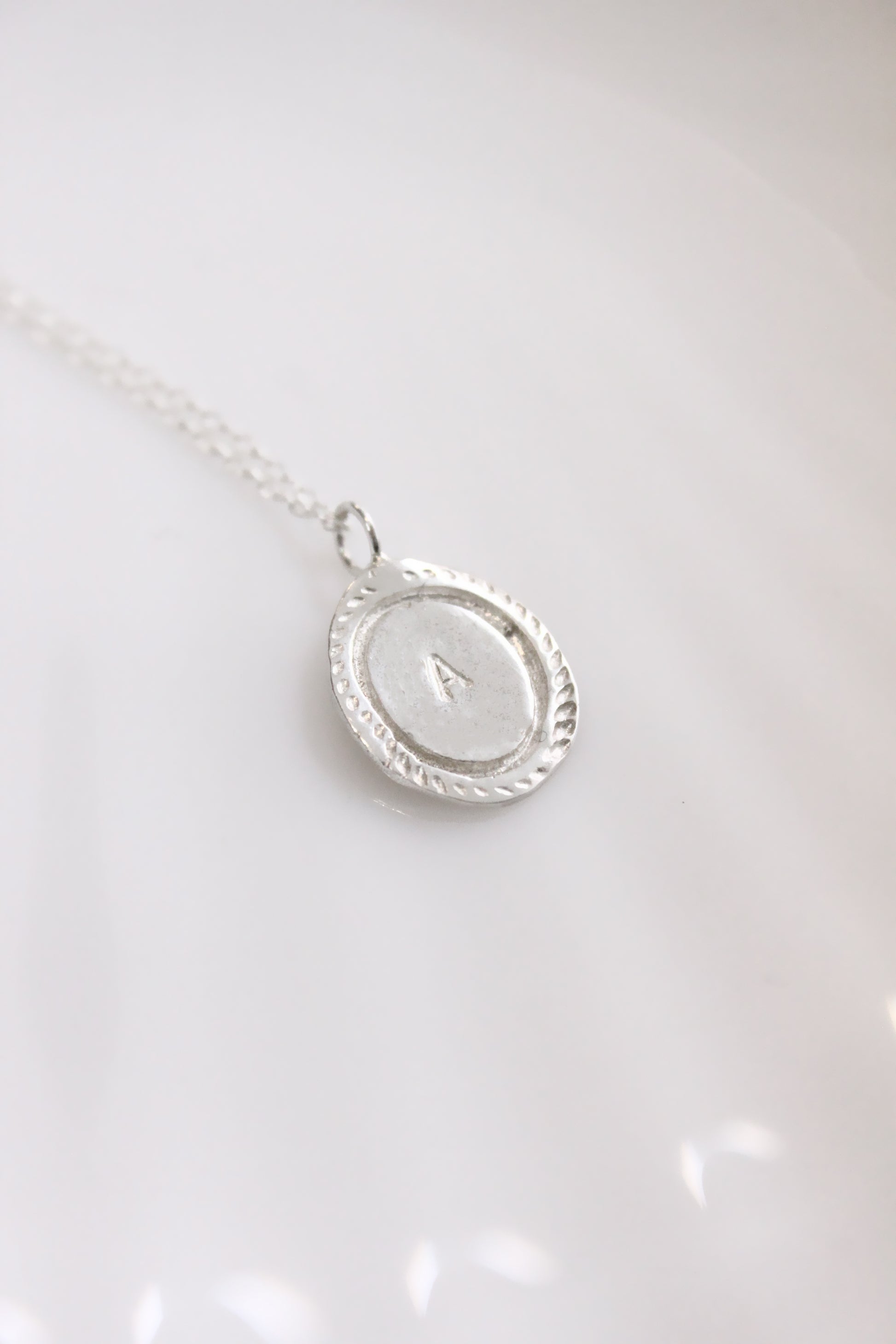 Silver necklace with a oval personalized initials monogram 