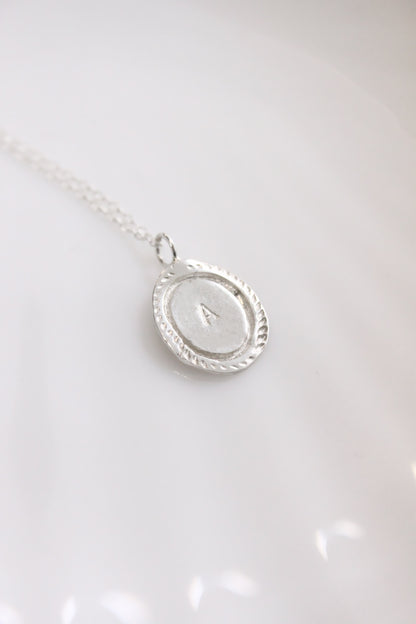 Silver necklace with a oval personalized initials monogram 