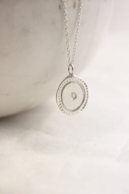 Silver necklace with a round personalized initials monogram 