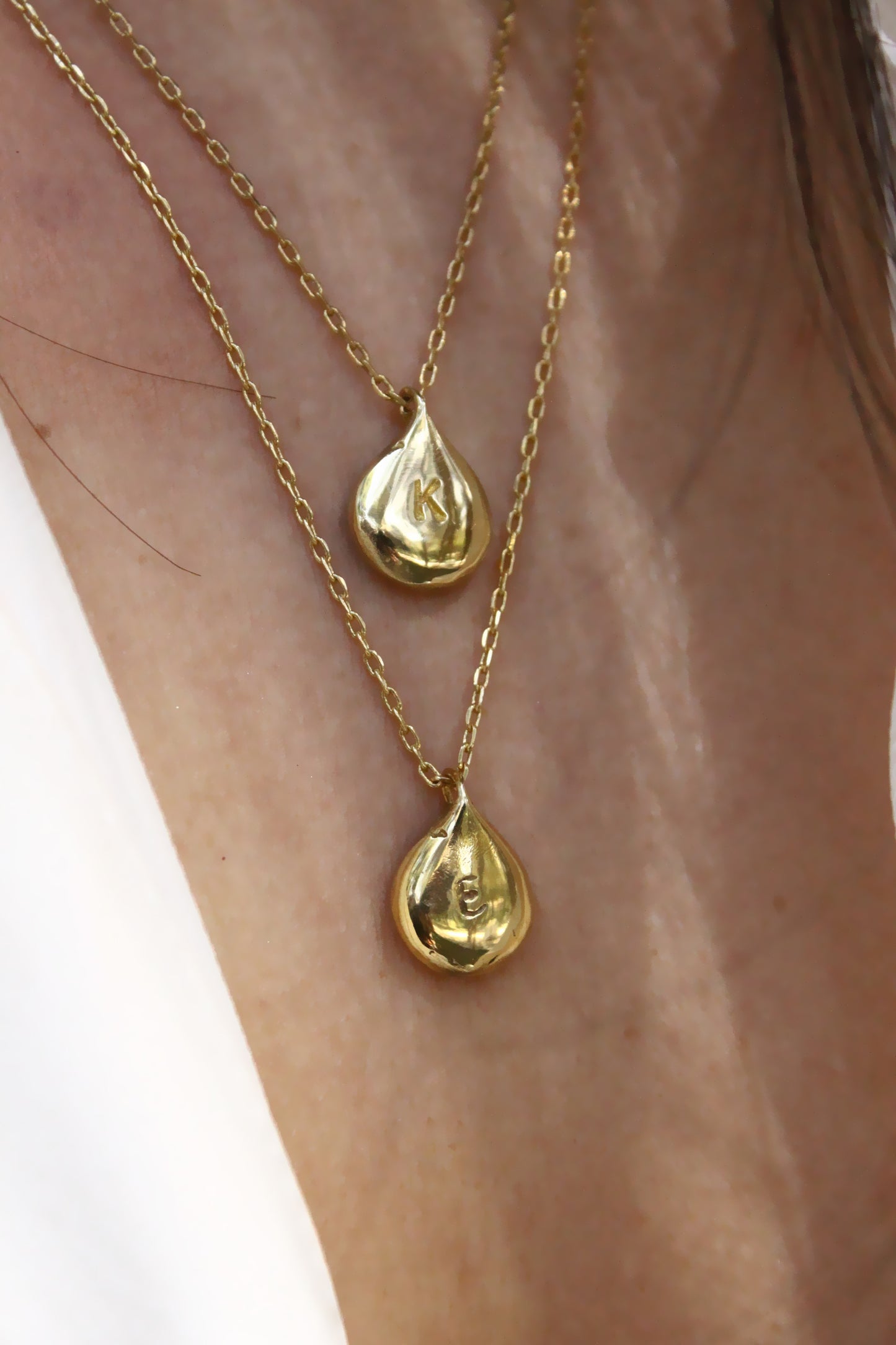 Two gold necklaces with teardrop personalized initials monogram 