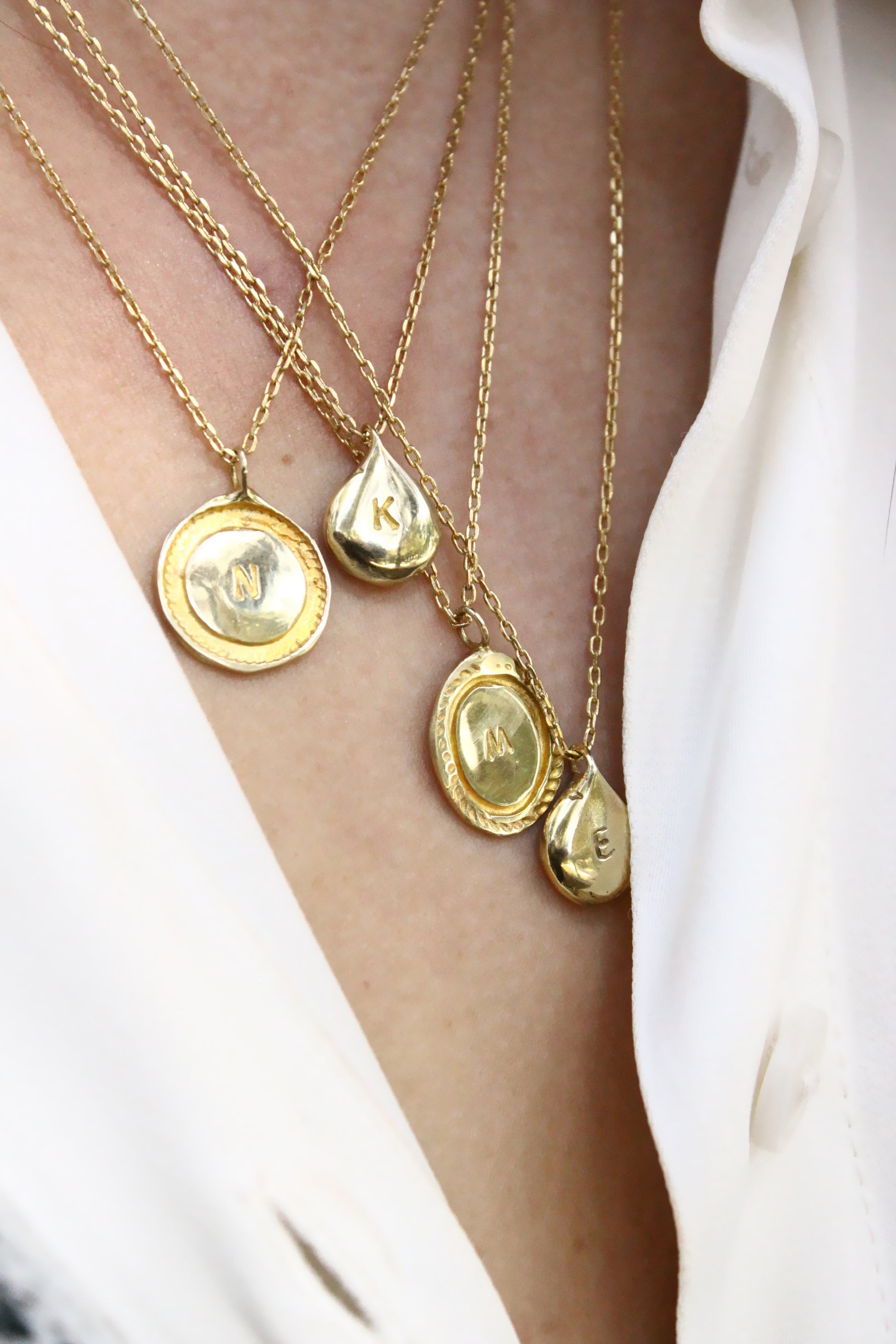 Close-up of gold personalized initials monogram necklace