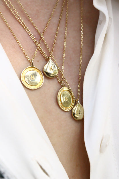 Close-up of gold personalized initials monogram necklace
