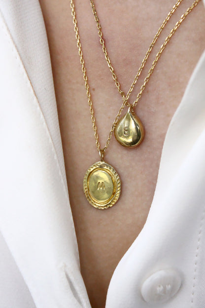 Two gold necklaces with monogram