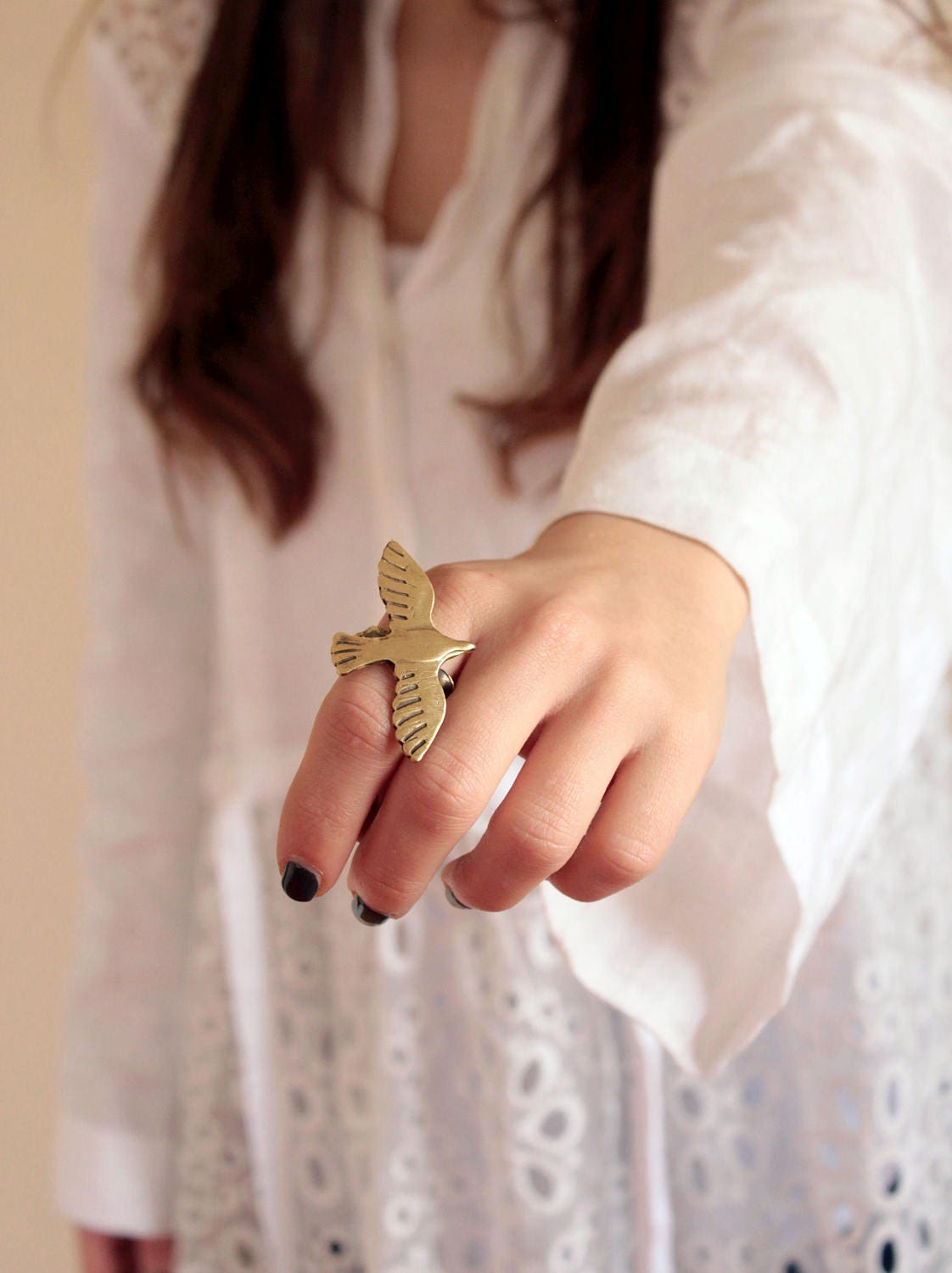 a gold bird-shaped ring